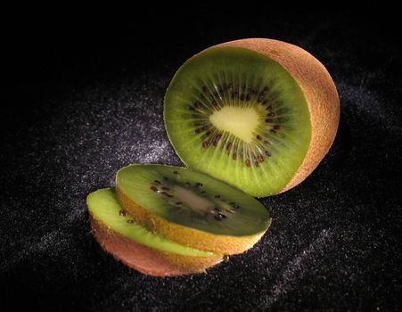 Jucy green kiwi on black velvet