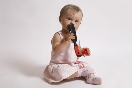  charming baby playing with comb