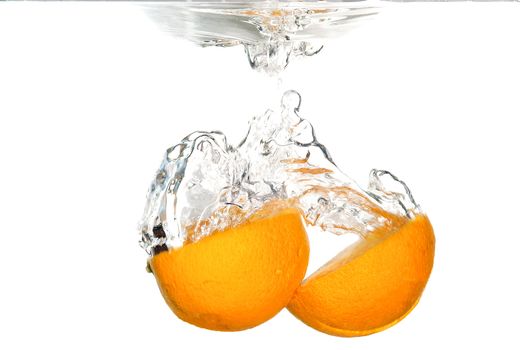 Splash of orange to water with bubbles of air