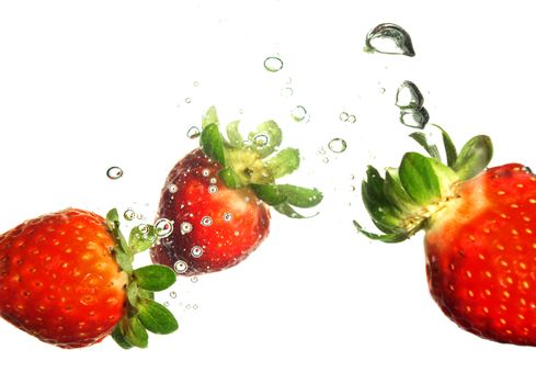 Splash of fresh strawberry to water with bubbles of air