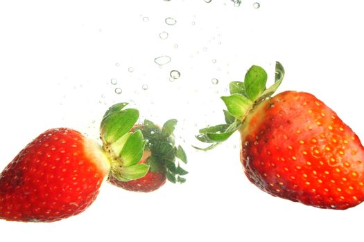 Splash of fresh strawberry to water with bubbles of air