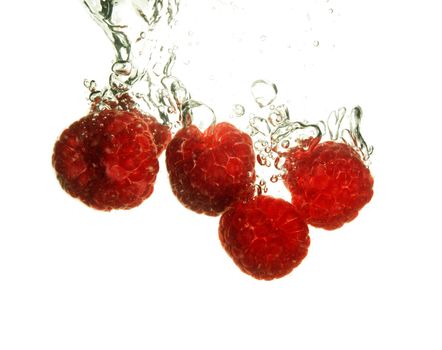 Splash of fresh raspberry to water with bubbles of air