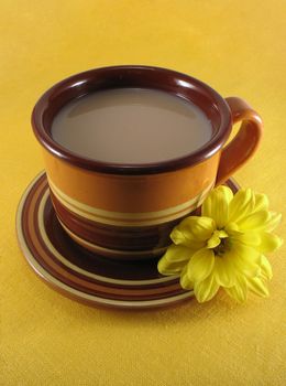 ceramic cup of tea on the yellow napkin