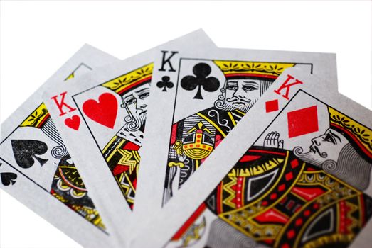 A fan of four Kings playing cards, isolated on a white background