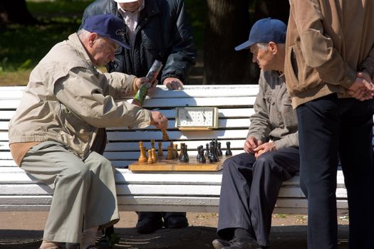 Two old mans playing in chess in city park. This a editorial photo woth no model releases