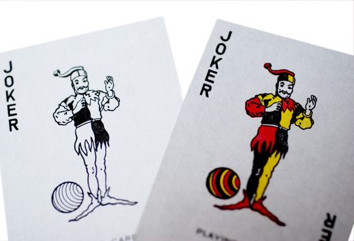 The two jokers from a set of playing cards, one in colour one in black and white, isolated on a white background