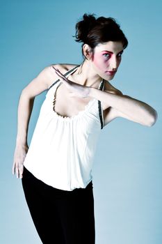 Studio portrait of a tall brunette with extreme make-up on