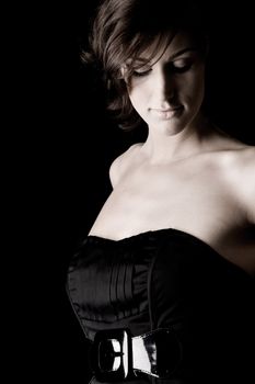 Studio portrait of a tall lady in a black dress on a black background