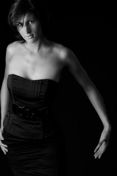 Studio portrait of a tall lady in a black dress on a black background