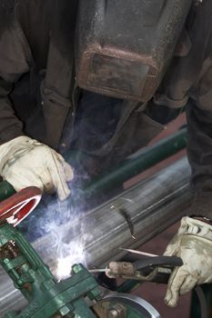 a welder working at shipyard during day shift