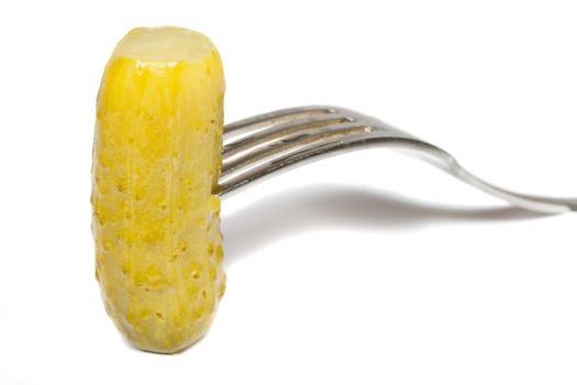 close-up marinated cucumber on fork, isolated on white