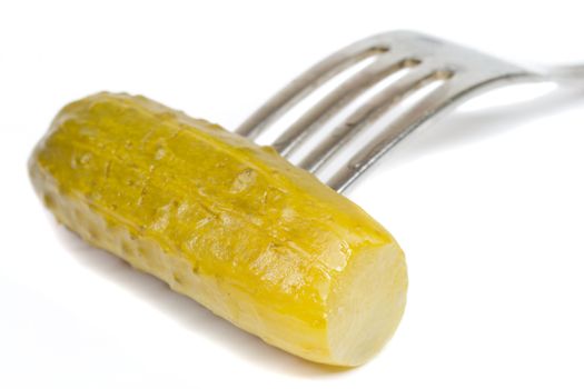 close-up pickled cucumber on fork, isolated on white