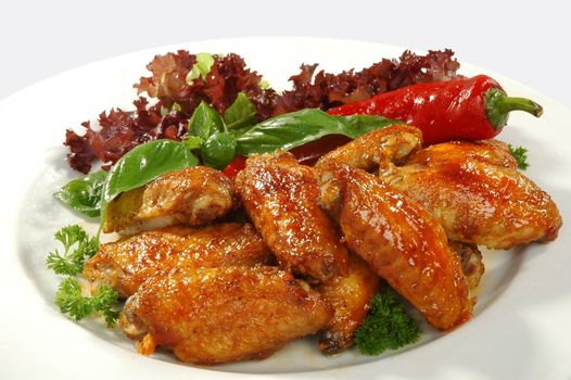 fried chicken wings in friture with red pepper