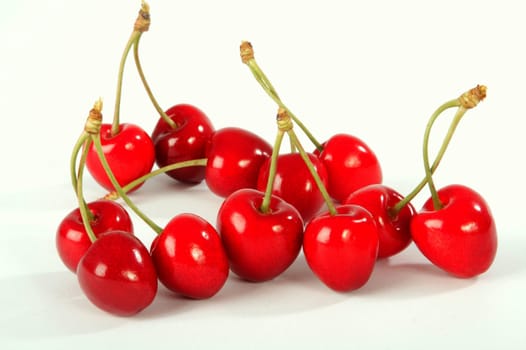 Ripe berries of a sweet cherry on a white sheet