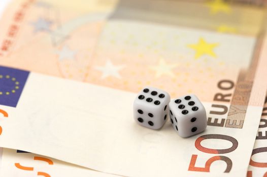 Dices over euro bills close up