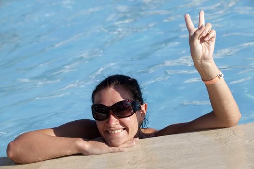 Beautiful woman enjoying summer in the pool