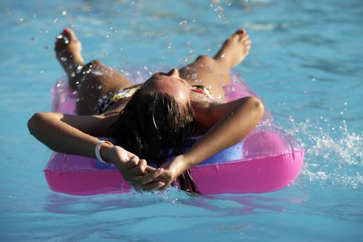 Beautiful woman enjoying summer in the pool