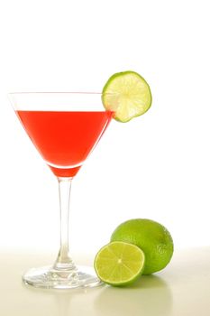 red and cold alcoholic drink with green lime