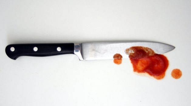 knife with red blood from crime or murder