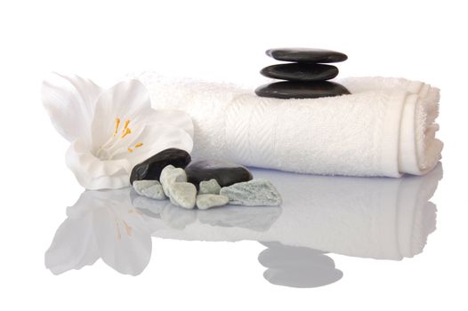 wellness zen and spa still life with flower towel and pebbles isolated on white