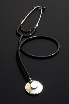 stethoscope on a black background showing health or medical concept
