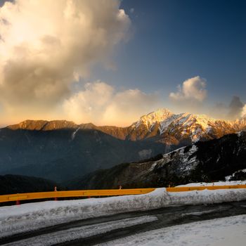 Landscape of dramatic scenery with orange sunset in snow peak in mountain Cilai, Taiwan, Asia.