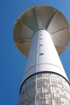 Guiding beacon for boats and ships over blue sky