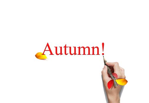 Woman is writing Autumn with a branch pencil