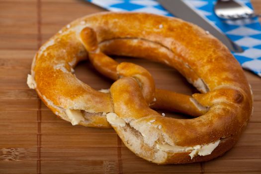 bavarian pretzel with butter isolated on white