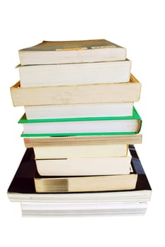 pile of different size books isolated on white background