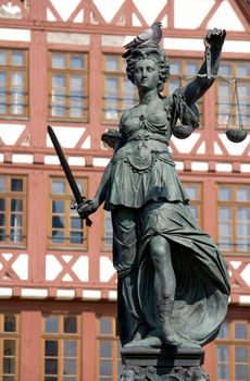 Statue of Lady Justice with a sleeping pigeon