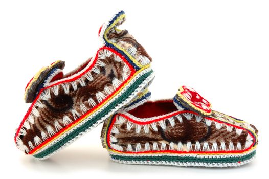 Baby's (childs) embroidered mocassins with leather sole on overwhite background.