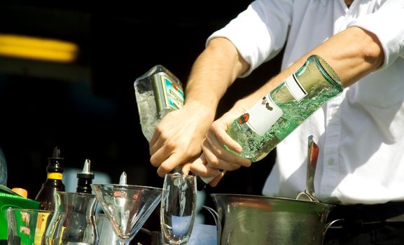 Hands of the barman mixing an alcoholic cocktail