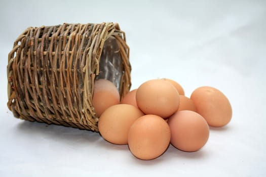 Fresh brown eggs and a wicker basket