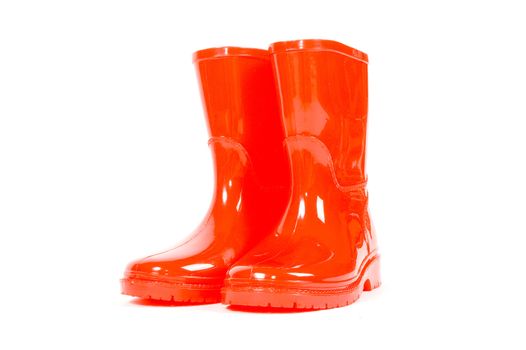Red children rain boots on a white background