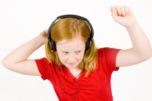 girl listening to music and dancing on white