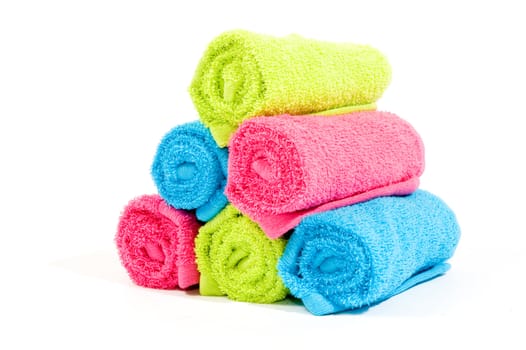 Colorful towel rolls on a white background