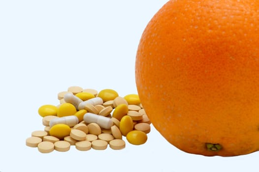 pills and orange isolated on the white background