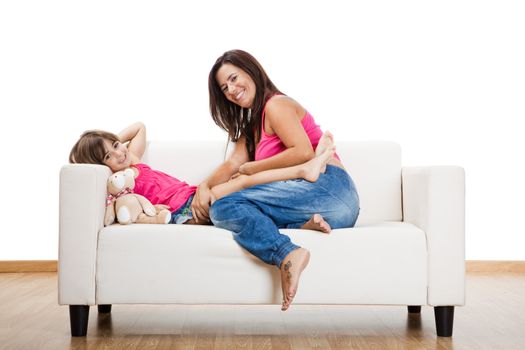 Beautiful pregnant mother with her daughter isolated on white
