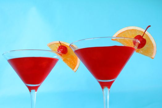 cocktails with orange and cherry garnish

