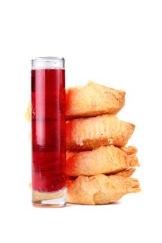 The red aerated drink in a high glass and rolls from the multilayered test.