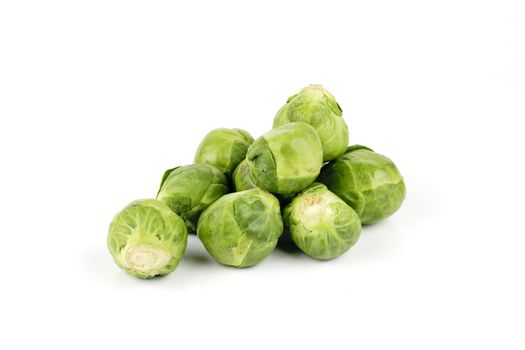Small pile of raw green sprouts on a reflective white background