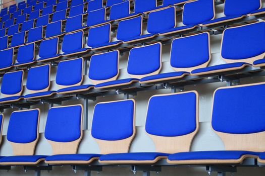 Rows of empty blue stadium seats background