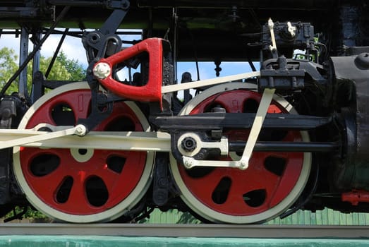 Red wheels of old soviet steam locomotive