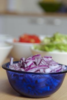 Red Onions on glass cup.