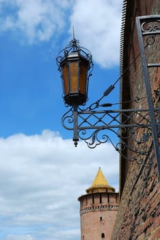 Decorative metal lamp on wall of old fortress in Kolomna town near Moscow