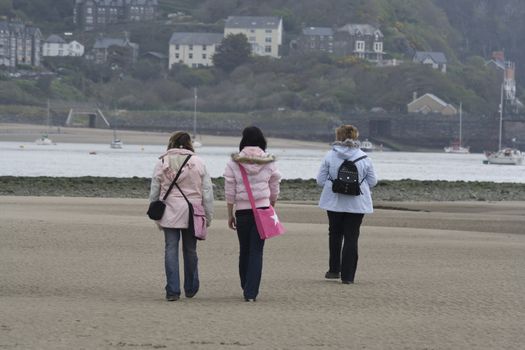 Family on the beach, in rain.