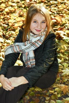 Portrait of a beautiful teenage girl in fall park