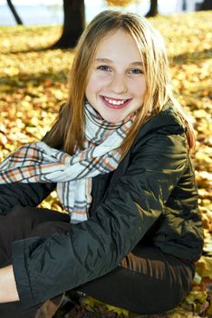 Portrait of a beautiful teenage girl in fall park