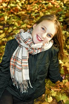 Portrait of a beautiful teenage girl in fall park